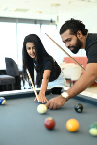 Dulaj teaching Yashodha how to play 8 ball pool during the 6IXSENES Digital Annual Huddle